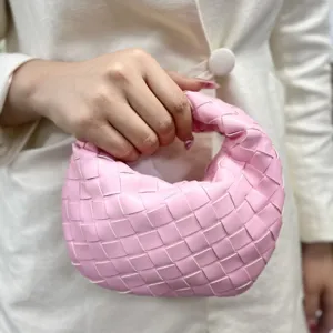 Pink woven leather handbag for women, stylish handmade handbag, trendy compact purse.