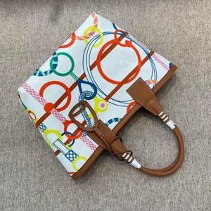 Stylish canvas tote bag with colorful bridle print and genuine leather trim, large capacity.