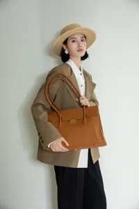Leather commuter tote bag detailed view, showcasing premium leather texture and spacious interior.