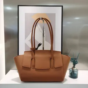 Detailed view of the premium brown leather tote bag showcasing fine texture and elegant style.