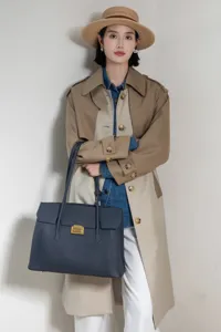 Dark blue leather tote bag detailed scene showing large capacity and commuting style.