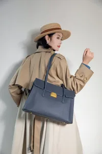 Genuine leather commuter shoulder bag with metal lock detail, premium top-layer cowhide.