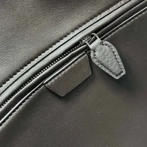 Detail shot of genuine leather bowling handbag zipper, premium brown cowhide texture and craftsmanship.