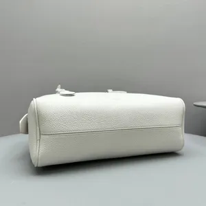 Detailed view of white top-layer cowhide bowling handbag, showcasing fine leather texture.