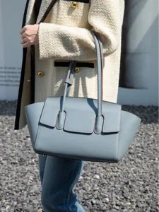 Luxury leather tote bag for women, elegant light blue shoulder bag with double straps.