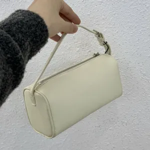 Minimalist white leather cylindrical shoulder bag, retro 90s style handbag for women.