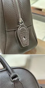 Premium brown leather bowling bag detail view, luxury style top handle handbag with exquisite zipper.