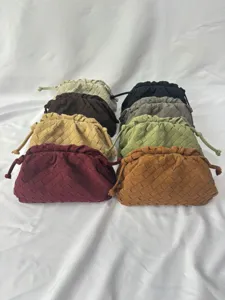 Detailed view of multiple woven leather clutch bags showcasing various vibrant colors.