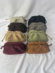 Woven leather clutch bag detail showing multiple color options and soft intrecciato texture.