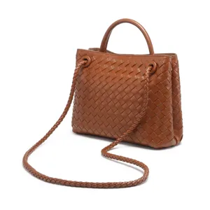 Brown woven leather tote bag, elegant vintage handbag with top handle and braided strap detail.