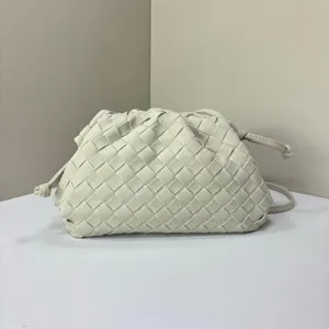 Chic beige woven clutch bag, vintage style suede-look pouch handbag for women and fashion detail.