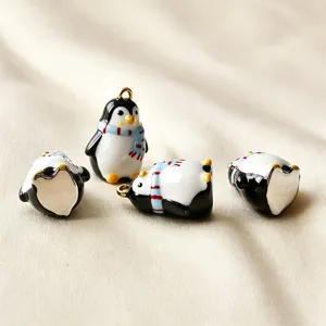 Detailansicht von süßen 3D-Pinguin-Emaille-Anhängern mit blauen Schals für DIY-Schmuck