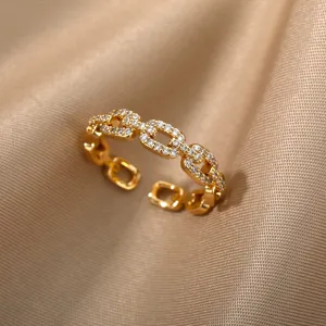 Detail view of 18K gold plated open ring with sparkling pavé set zircons on satin.