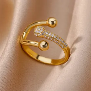 Close-up of elegant 18K gold plated open ring with pavé zircons and polished spheres