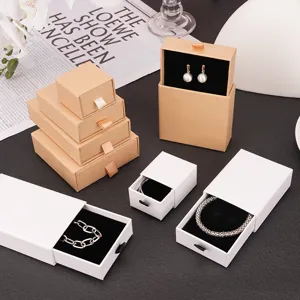 Elegant jewelry gift drawer boxes in white and kraft for necklaces and rings.