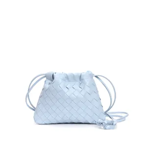 Detailed view of the light blue woven leather pouch bag showing soft dumpling shape.