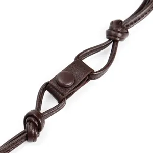 Brown leather bag strap detail showing adjustable snap button and secure knots clearly.
