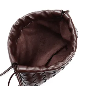 Leather woven pouch bag interior detail, brown intrecciato drawstring cosmetic dumpling bag.