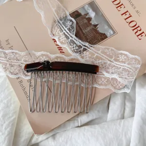 Close-up detail of the elegant tortoise shell hair comb with metal teeth for women styling.