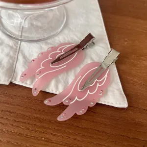 Pink frosted angel wing hair clips with sparkling rhinestones, sweet metal side hairpin details.
