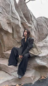 Detailed view of large suede hobo tote bag in outdoor scene, chic daily commute fashion.