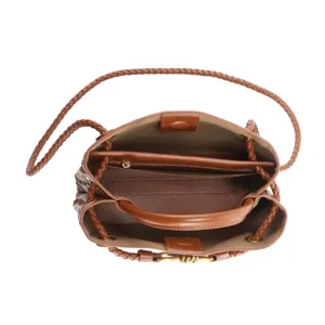 Brown woven leather bucket bag interior detail, spacious design with zipper compartment.