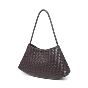 Dark brown woven leather shoulder bag detail, showcasing intricate handcrafted intrecciato pattern.