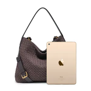 Detailed view of dark brown woven suede hobo bag shown with size reference tablet.