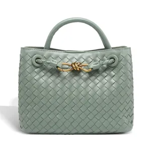 Green woven leather handbag with top handle and metal knot detail for women stylish