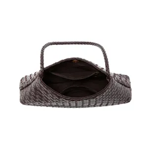 Closeup of dark burgundy woven leather shoulder bag interior and braided handle detail.