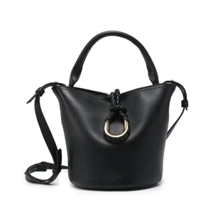 Black leather bucket bag with top handle and strap, featuring braided knot and metal ring detail.