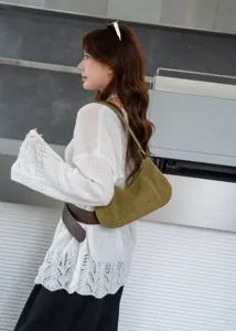 Detail shot of green suede hobo shoulder bag, showing premium texture, compact size and elegant design.