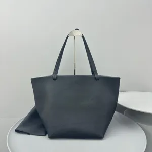 Minimalist black leather tote bag for women, large capacity commuter shoulder bag with pouch.