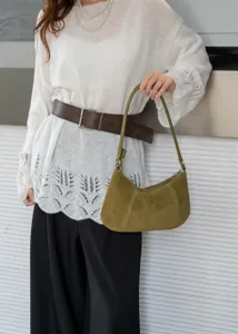 Olive green suede underarm shoulder bag for women, stylish minimalist handbag detail view.
