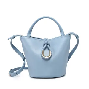 Light blue bucket bag detail showing the braided knot and metallic ring design element.