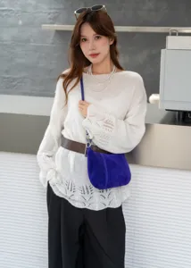 Blue suede underarm shoulder bag detail showing soft leather texture and stylish everyday look.