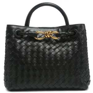 Black woven leather tote bag with metal knot handle top view professional product photo