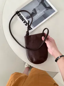 Borsa a tracolla minimalista in pelle marrone scuro per telefono con elegante nodo.