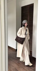 Detailed view of a brown suede women shoulder bag with flap and metal lock in daily scene.