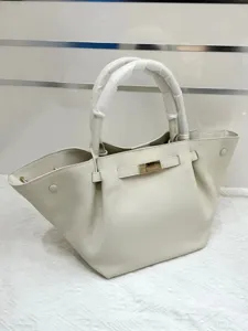Cream white leather winged handbag detail, top handle bag with metallic lock closure.