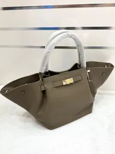 Genuine leather winged tote bag for women, stylish top handle shoulder bag with lock.