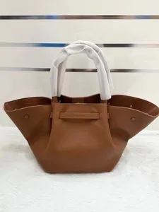 Elegant brown leather winged tote bag, stylish fashion casual handbag for women.