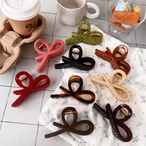 Detailed view of stylish ribbon hair claws in multiple colors, featuring a chic bow design.