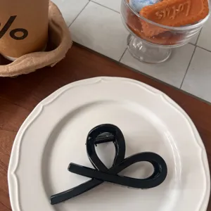 Black ribbon hair claw clip stylish geometric hair accessory for women daily wear detailed shot.