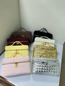 Assorted woven cosmetic bags with top handle and metal zipper, colorful handheld travel cases.