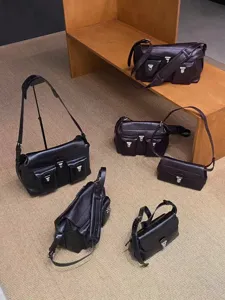 Multiple leather messenger bags showing different angles and sizes on shelf and floor display.