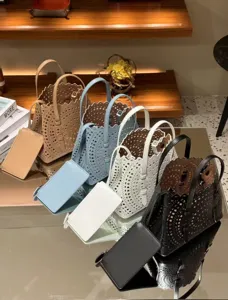 Chic laser-cut leather tote bag set with matching pouch, versatile casual handbag.