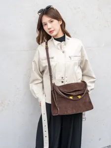 Detailed view of the retro brown suede shoulder bag showcasing premium leather texture.