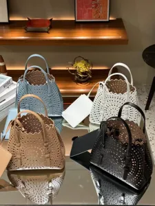 Stylish leather perforated tote bag with top handles, chic casual crossbody bag for women.
