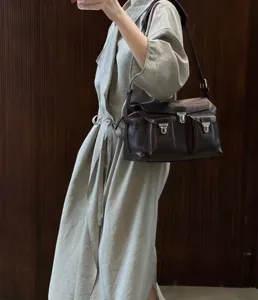 Dark brown leather messenger bag with multiple front pockets, vintage style shoulder bag for women.